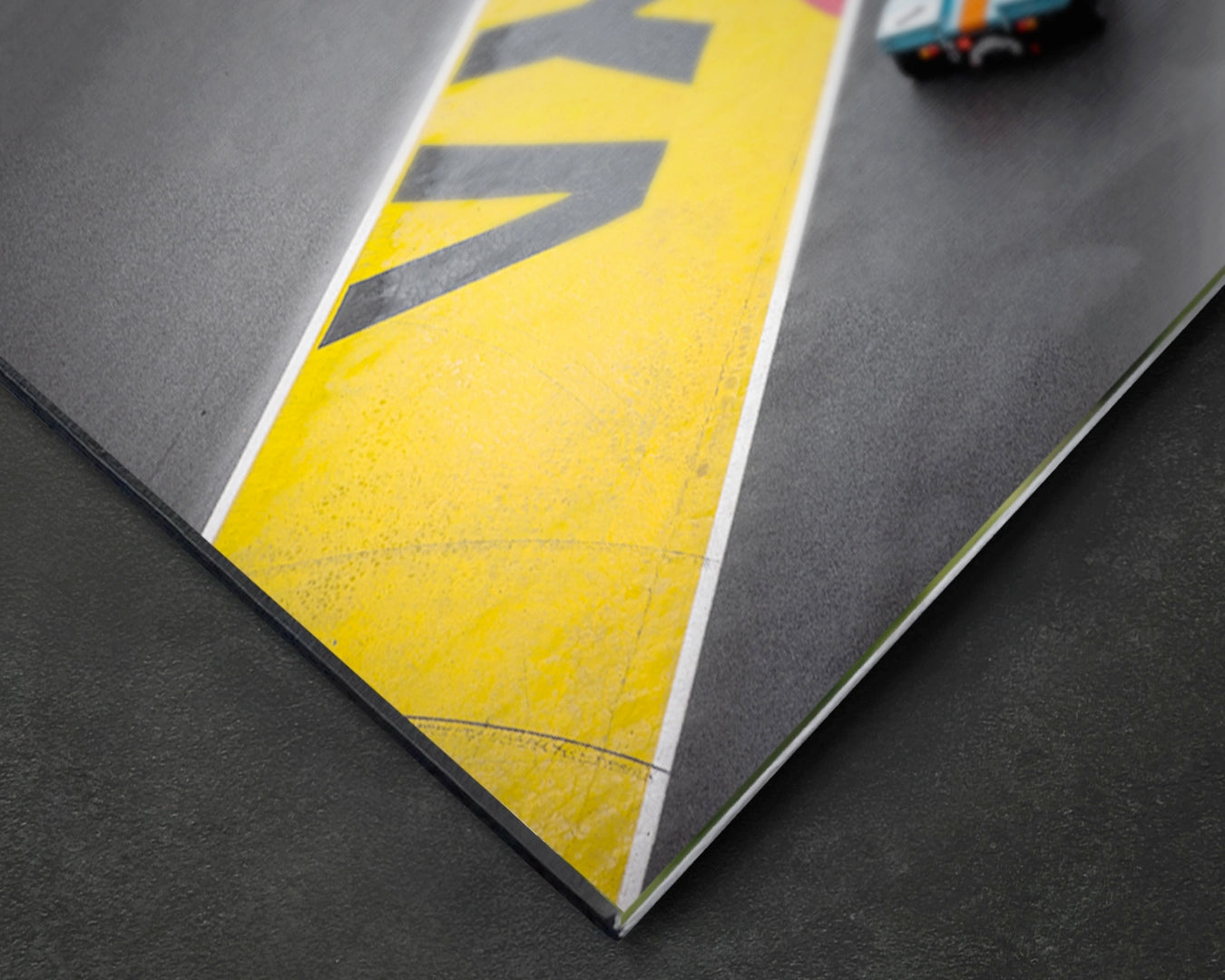 Close-up of Porsche 917K stripe aluminium print showing yellow detail on satin aluminium surface