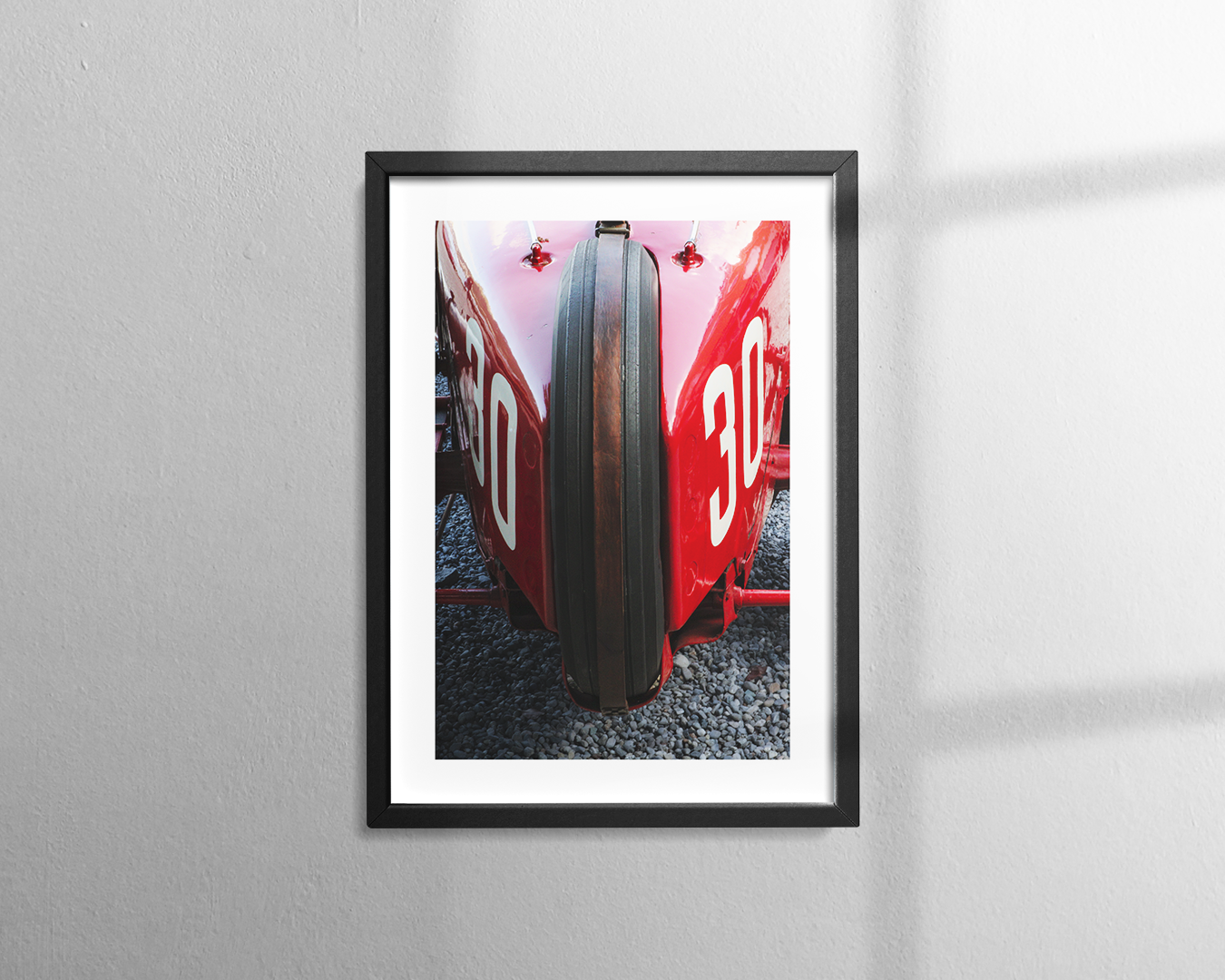 A close-up of the rear of a vintage red Alfa Romeo racing car with the number 30 visible
