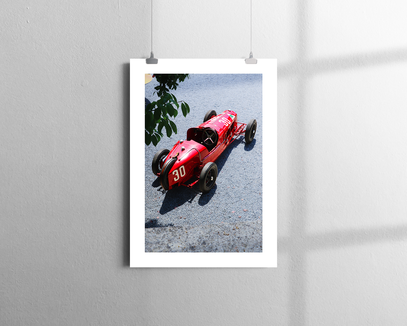 A bright red, vintage open-wheel race car