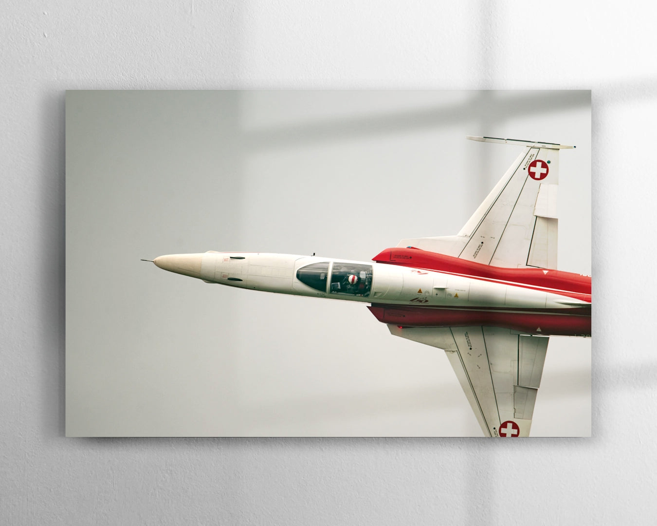Patrouille Suisse F-5 Tiger II in red and white livery isolated against open sky photographed at Axalp Ebenfluh military airshow Switzerland