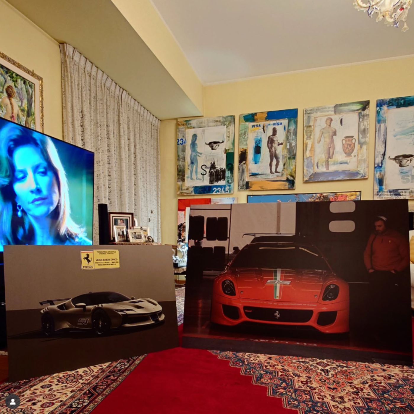 Large format limited edition motorsport artworks displayed in a private collector's space.