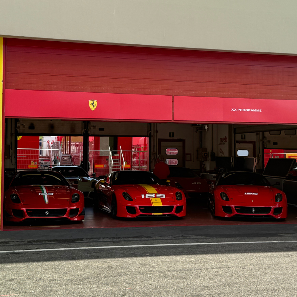 Three 599XX in a garage on a race track