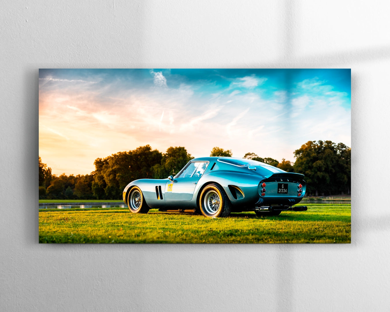 Ferrari 250 GTO chassis 3387GT in Blu Genziana photographed at golden hour showing Kamm tail and wire-spoke wheels on green grass