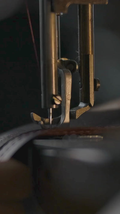Close-up of uncompromising Italian leathercraft, preparing The Vault desk object for serious Ferrari and motorsport collectors.